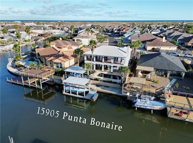 bird's eye view featuring a water view and a residential view