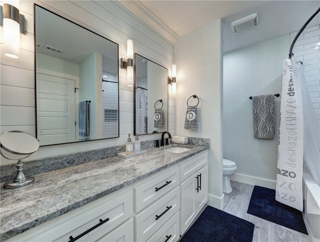 full bathroom with vanity, shower / bath combo, and toilet