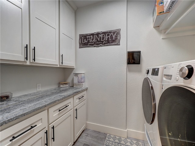 laundry room with cabinets and independent washer and dryer