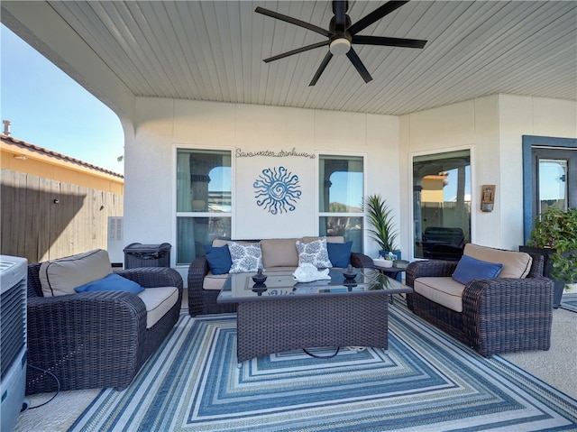 view of patio with ceiling fan and an outdoor living space