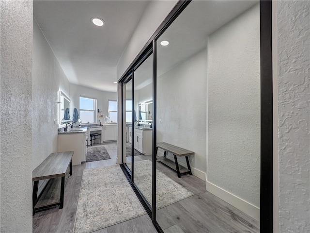 corridor with light hardwood / wood-style flooring