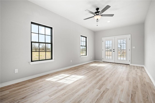 unfurnished room featuring light wood finished floors, ceiling fan, french doors, and baseboards