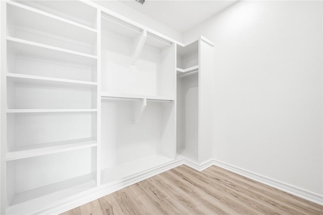 walk in closet featuring wood finished floors