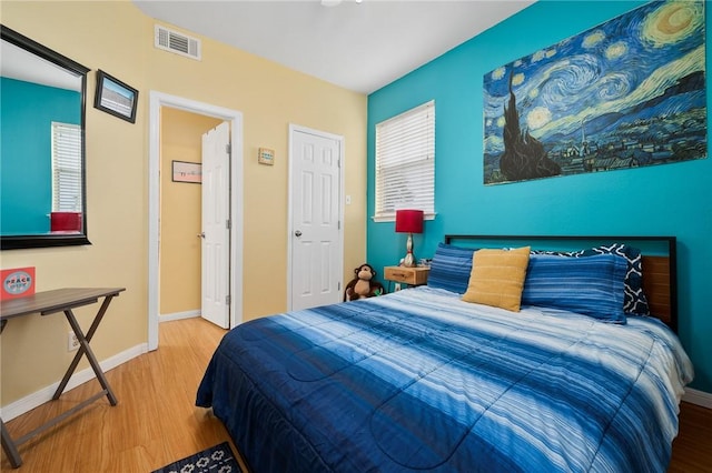 bedroom with hardwood / wood-style flooring