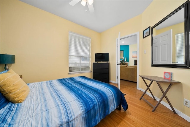 bedroom with ceiling fan and hardwood / wood-style floors