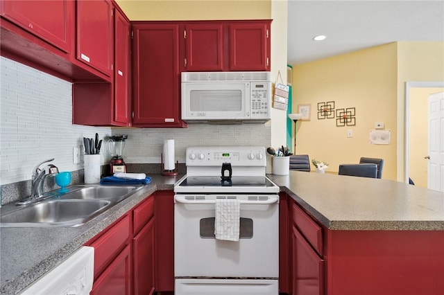 kitchen featuring sink, white appliances, and tasteful backsplash