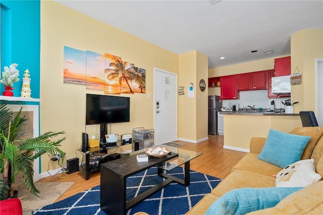 living room with light hardwood / wood-style flooring