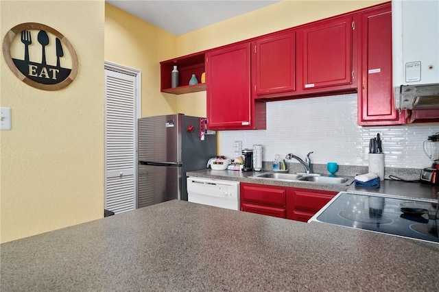 kitchen featuring water heater, stainless steel fridge, decorative backsplash, white dishwasher, and sink