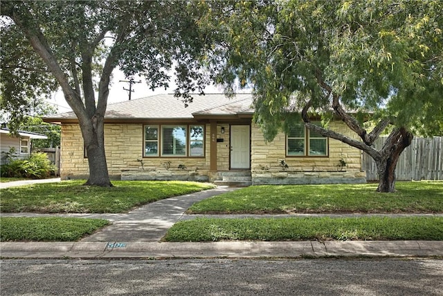 606 Grant Pl, Corpus Christi, TX 78411 - view of front of house featuring stone siding and roof with shingles