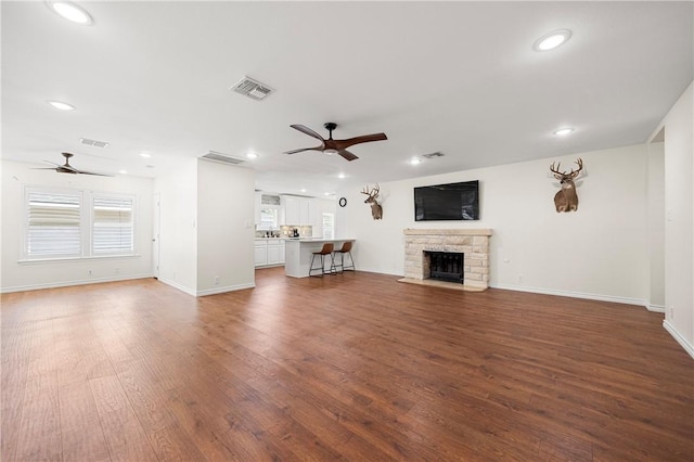 606 Grant Pl, Corpus Christi, TX 78411 - unfurnished living room with a ceiling fan, recessed lighting, wood finished floors, and a fireplace