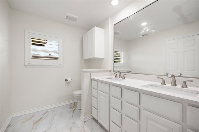 606 Grant Pl, Corpus Christi, TX 78411 - bathroom with double vanity, marble finish floors, and recessed lighting