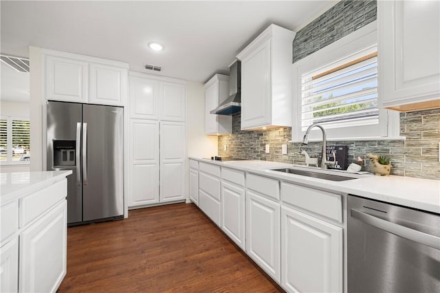 606 Grant Pl, Corpus Christi, TX 78411 - kitchen with appliances with stainless steel finishes, wall chimney exhaust hood, healthy amount of natural light, tasteful backsplash, and recessed lighting