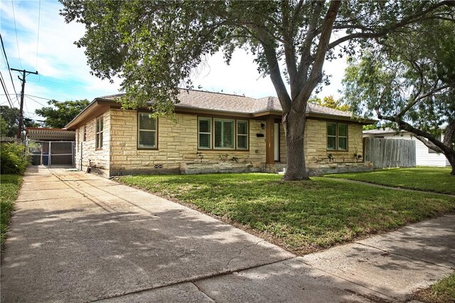 606 Grant Pl, Corpus Christi, TX 78411 - single story home with stone siding and driveway