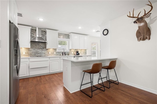 606 Grant Pl, Corpus Christi, TX 78411 - kitchen with wall chimney exhaust hood, stainless steel fridge with ice dispenser, decorative backsplash, dark wood-style flooring, and recessed lighting