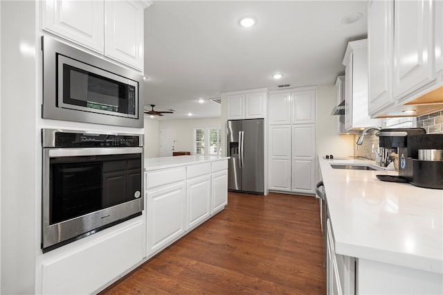 606 Grant Pl, Corpus Christi, TX 78411 - kitchen with stainless steel appliances, white cabinets, light countertops, and recessed lighting