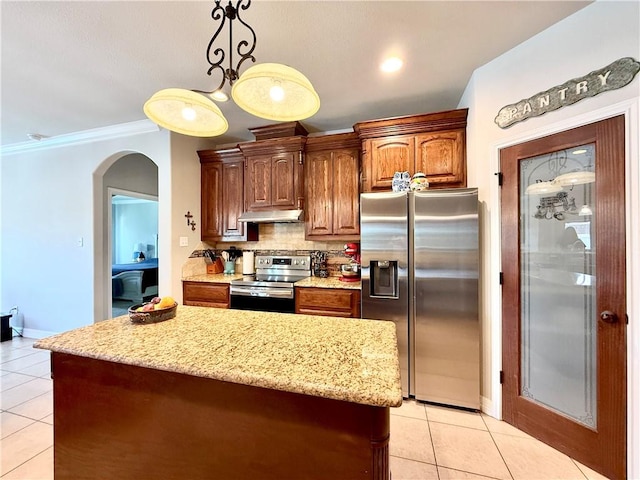 6717 Battery Park Ct, Corpus Christi, TX 78414 - kitchen with appliances with stainless steel finishes, light tile patterned flooring, tasteful backsplash, light stone countertops, and arched walkways
