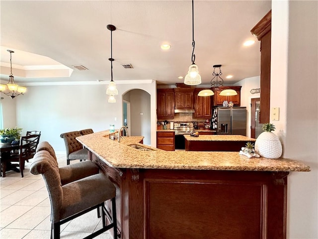 6717 Battery Park Ct, Corpus Christi, TX 78414 - kitchen with appliances with stainless steel finishes, ornamental molding, arched walkways, recessed lighting, and a breakfast bar area