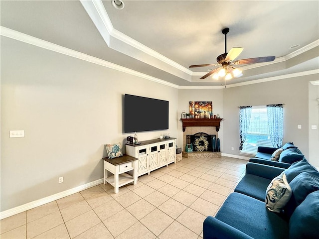6717 Battery Park Ct, Corpus Christi, TX 78414 - living area with a raised ceiling, light tile patterned floors, ornamental molding, ceiling fan, and a tiled fireplace