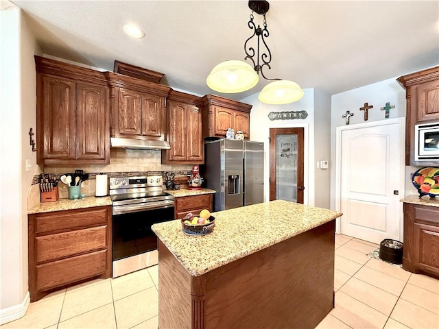 6717 Battery Park Ct, Corpus Christi, TX 78414 - kitchen with appliances with stainless steel finishes, under cabinet range hood, tasteful backsplash, and light tile patterned flooring