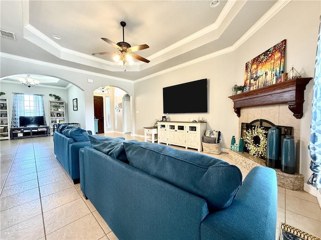 6717 Battery Park Ct, Corpus Christi, TX 78414 - living area featuring a tray ceiling, light tile patterned flooring, arched walkways, crown molding, and a ceiling fan