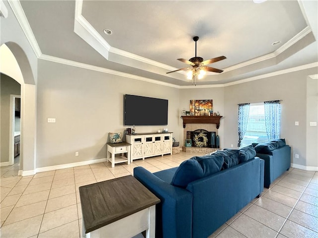 6717 Battery Park Ct, Corpus Christi, TX 78414 - living area featuring a tray ceiling, light tile patterned flooring, a ceiling fan, and crown molding