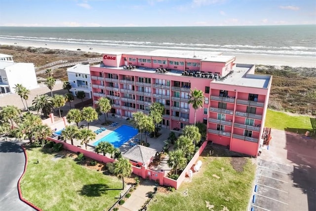 drone / aerial view featuring a beach view and a water view