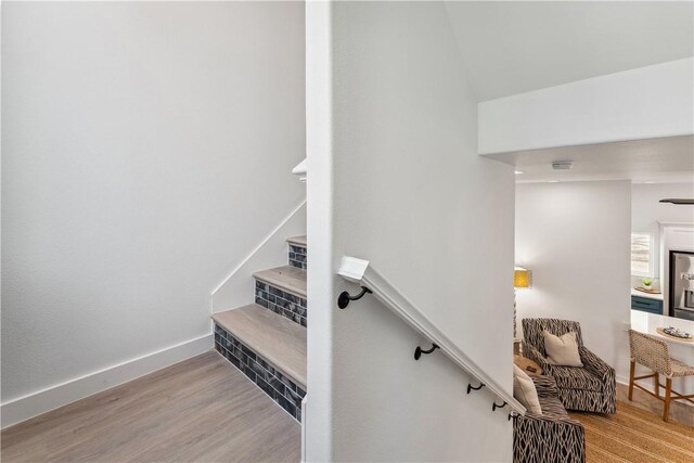 stairs featuring baseboards and wood finished floors
