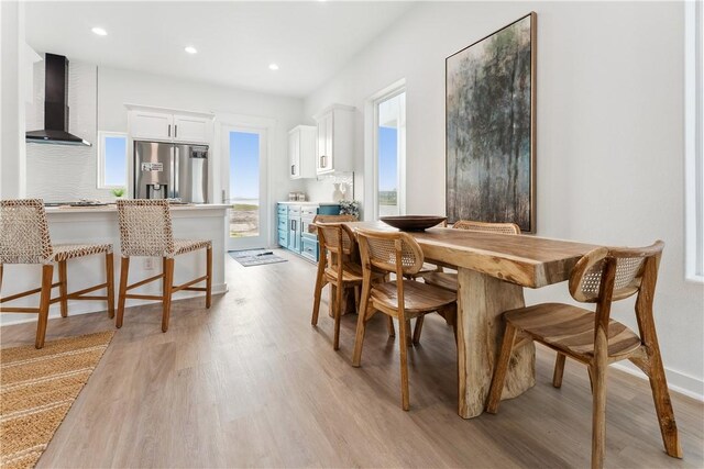 dining area featuring recessed lighting, baseboards, and light wood finished floors