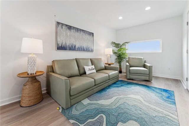 living room featuring recessed lighting, baseboards, and wood finished floors