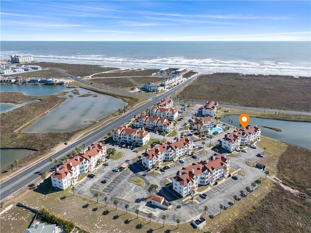 birds eye view of property featuring a water view and a view of the beach