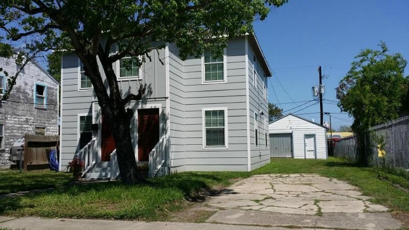 back of house featuring a garage and an outdoor structure