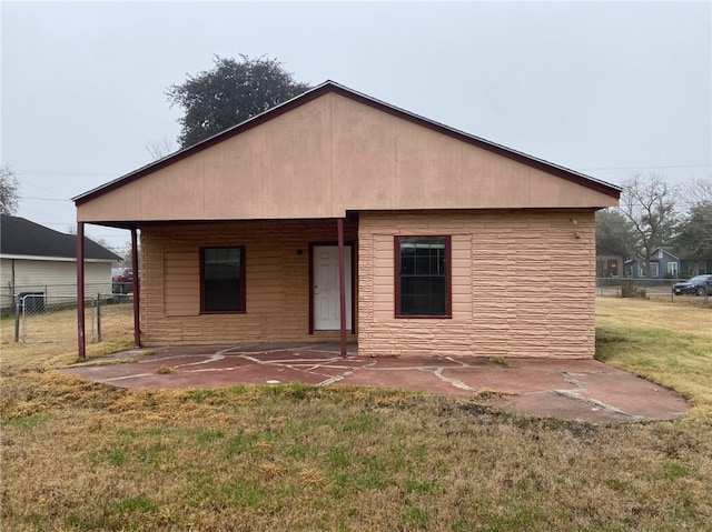 back of property featuring a lawn and a patio area