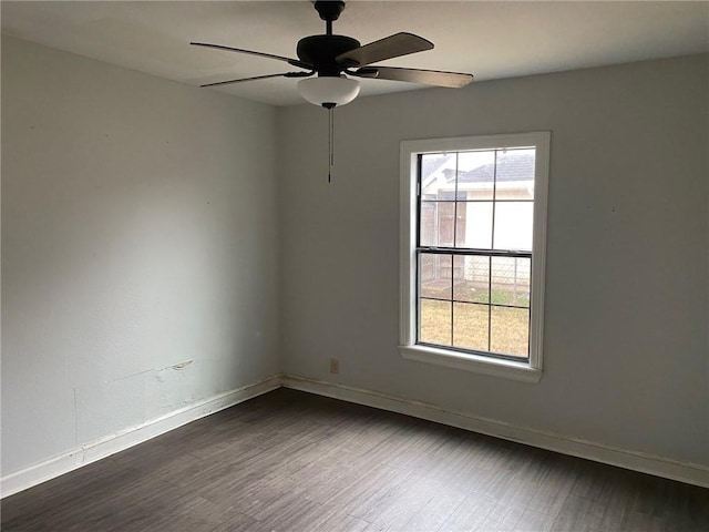 empty room featuring dark wood-type flooring and ceiling fan