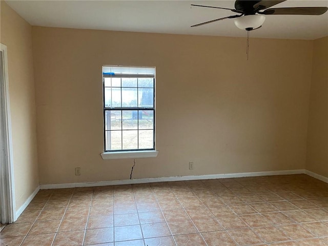 tiled spare room with ceiling fan