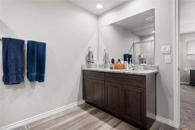 7218 Tristan, Corpus Christi, TX 78414 - full bathroom with double vanity, a stall shower, wood finished floors, and baseboards