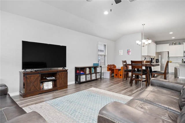 7218 Tristan, Corpus Christi, TX 78414 - living room with a ceiling fan, light wood-style floors, vaulted ceiling, a chandelier, and baseboards