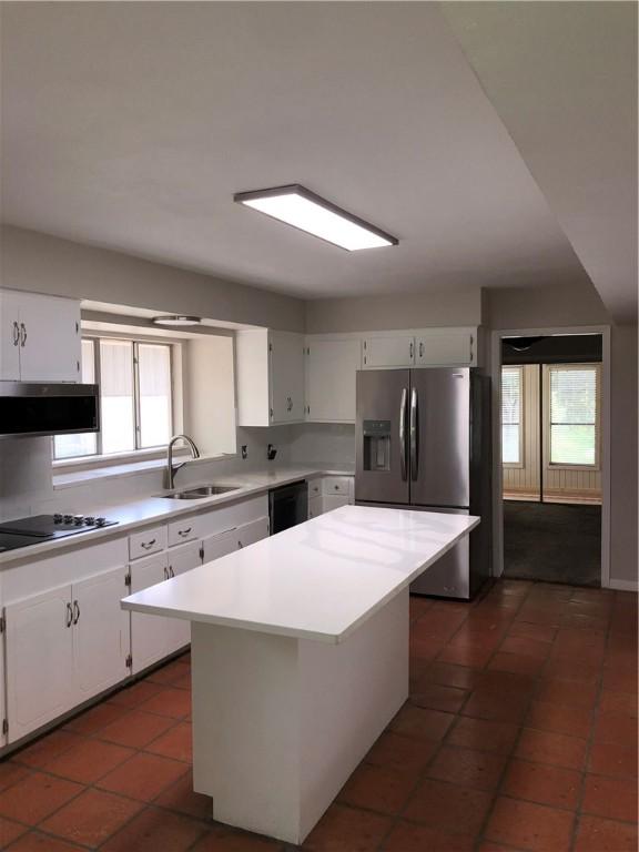 kitchen with white cabinetry, a kitchen island, sink, and black appliances