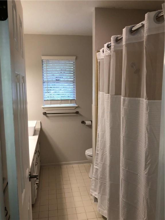 bathroom featuring tile patterned floors, vanity, and toilet