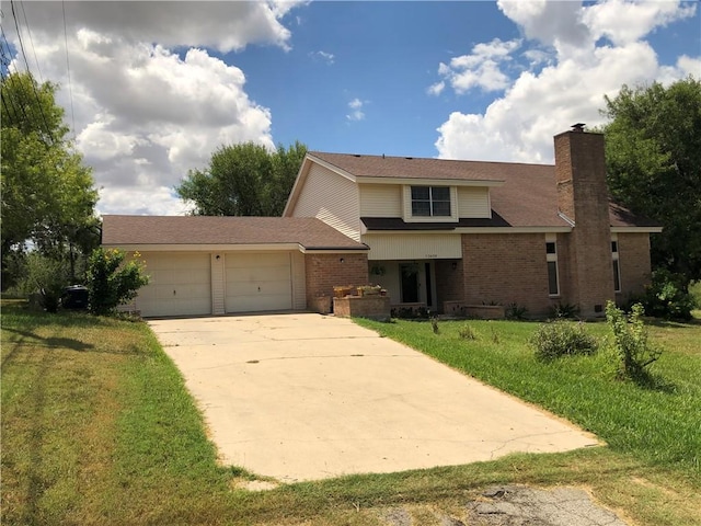 view of front facade with a garage and a front lawn