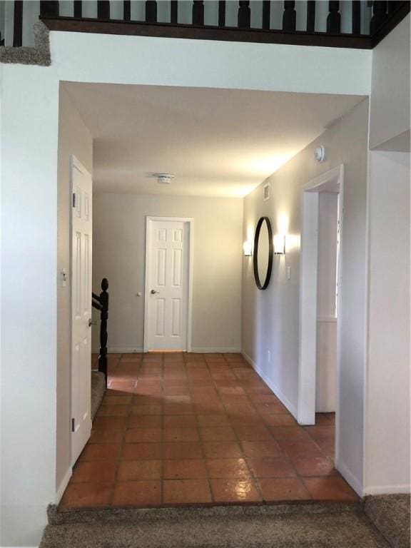 corridor with dark tile patterned flooring