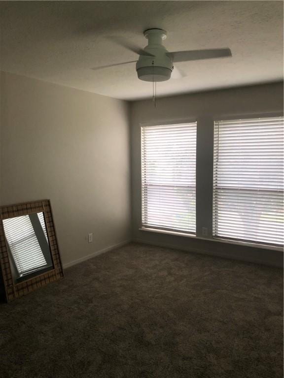 empty room with ceiling fan and carpet