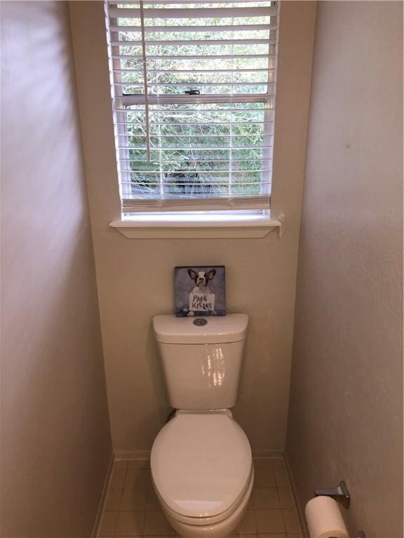 bathroom featuring toilet and tile patterned flooring