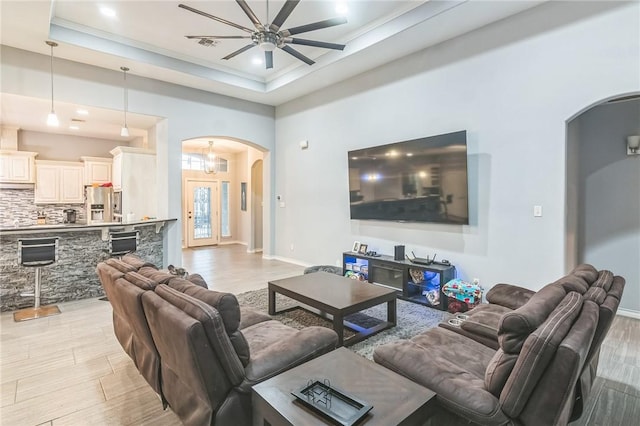 6705 Empire State Dr, Corpus Christi, TX 78414 - living room with arched walkways, ceiling fan, light wood-type flooring, a raised ceiling, and recessed lighting