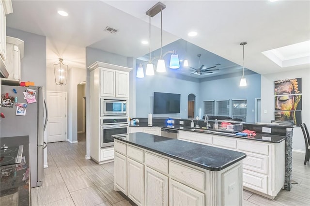 6705 Empire State Dr, Corpus Christi, TX 78414 - kitchen with stainless steel appliances, a peninsula, a ceiling fan, a center island, and open floor plan