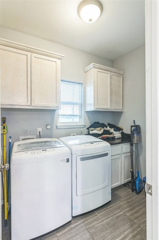 6705 Empire State Dr, Corpus Christi, TX 78414 - washroom with cabinet space, washing machine and dryer, and wood finished floors