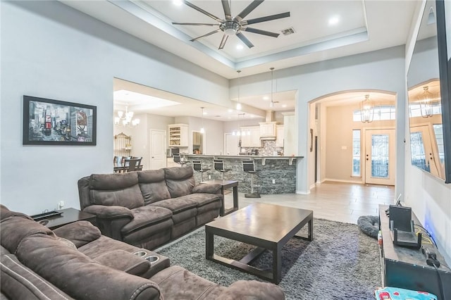 6705 Empire State Dr, Corpus Christi, TX 78414 - living room with a chandelier, arched walkways, ceiling fan, recessed lighting, and a tray ceiling