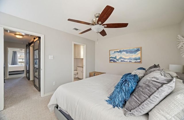 bedroom featuring baseboards, visible vents, connected bathroom, light colored carpet, and ceiling fan