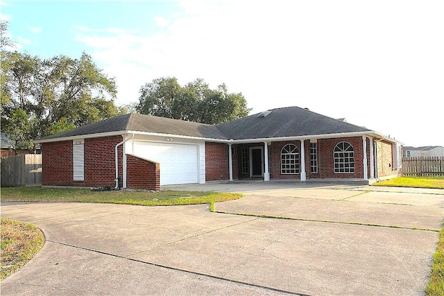 4125 Rapids Dr, Corpus Christi, TX 78410 - view of front of property featuring brick siding, concrete driveway, and a garage