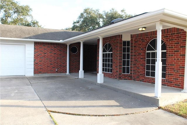 4125 Rapids Dr, Corpus Christi, TX 78410 - entrance to property with an attached garage, brick siding, and concrete driveway