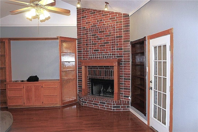 4125 Rapids Dr, Corpus Christi, TX 78410 - unfurnished living room featuring vaulted ceiling, wood finished floors, a ceiling fan, and a brick fireplace